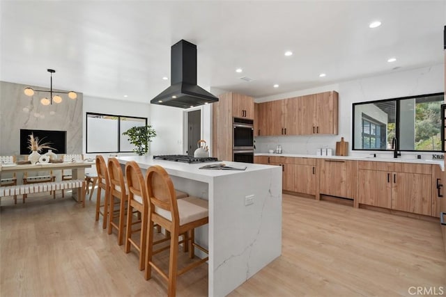 2037 Rayshire St, Thousand Oaks, CA 91362 - kitchen with island exhaust hood, stainless steel double oven, a center island, healthy amount of natural light, and recessed lighting