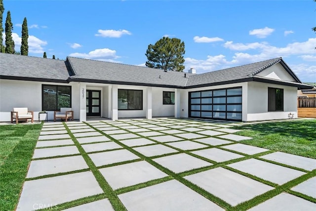 2037 Rayshire St, Thousand Oaks, CA 91362 - rear view of property with stucco siding, an outdoor hangout area, a garage, a shingled roof, and a yard