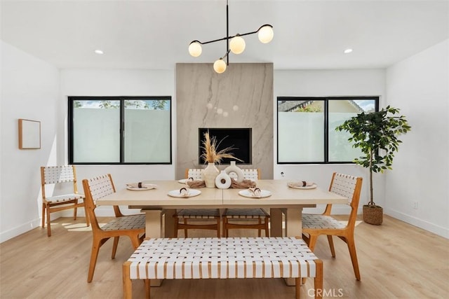 dining room with baseboards, recessed lighting, and light wood-style flooring