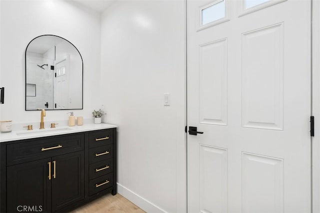 2037 Rayshire St, Thousand Oaks, CA 91362 - full bath with vanity, baseboards, wood finished floors, and a shower