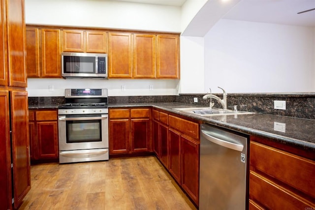 422 Cool Creek Ct Unit 5, Brawley, CA 92227 - kitchen with stainless steel appliances, wood finished floors, and dark stone counters
