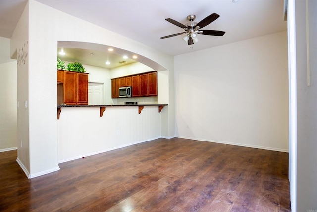 422 Cool Creek Ct Unit 5, Brawley, CA 92227 - unfurnished living room with ceiling fan, dark wood-type flooring, recessed lighting, and arched walkways