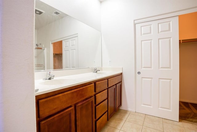 422 Cool Creek Ct Unit 5, Brawley, CA 92227 - bathroom featuring double vanity, tile patterned floors, a spacious closet, and a shower