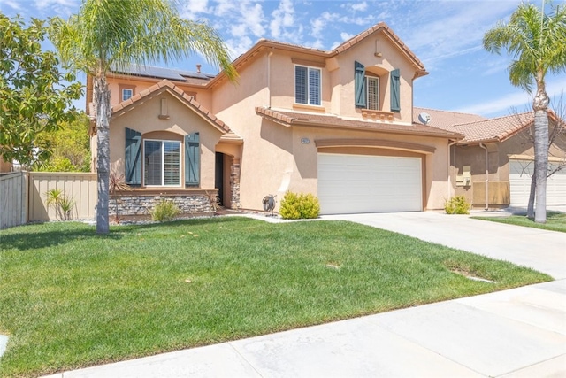 mediterranean / spanish house with concrete driveway, stucco siding, a front yard, a tile roof, and fence