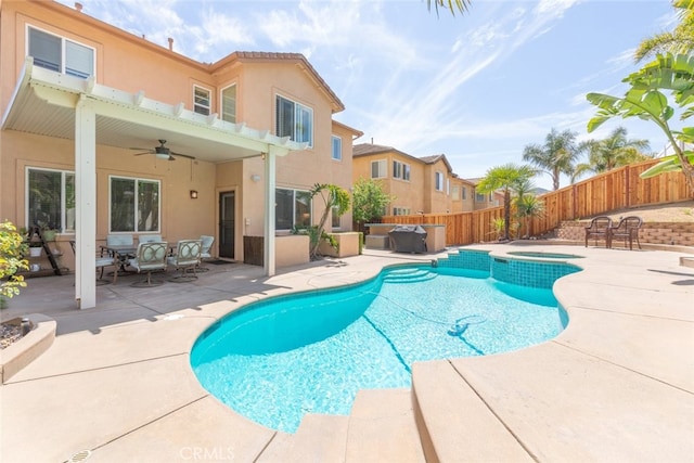 view of pool featuring a patio area, ceiling fan, a fenced backyard, an in ground hot tub, and a fenced in pool
