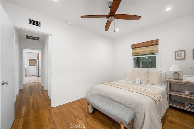 bedroom with recessed lighting, wood finished floors, and visible vents