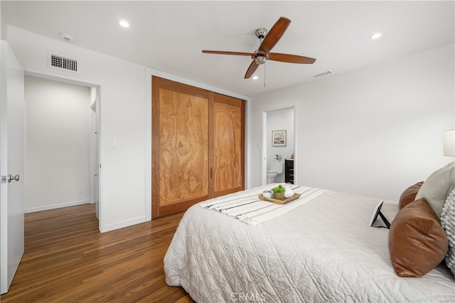 bedroom featuring recessed lighting, a closet, wood finished floors, and visible vents