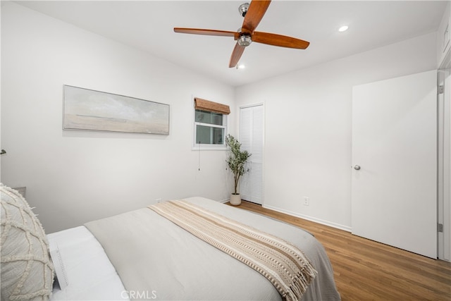 bedroom with ceiling fan, wood finished floors, and recessed lighting