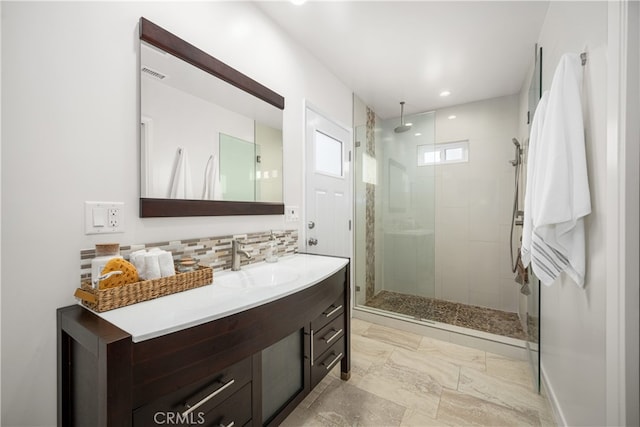 bathroom featuring a shower stall, backsplash, vanity, and visible vents
