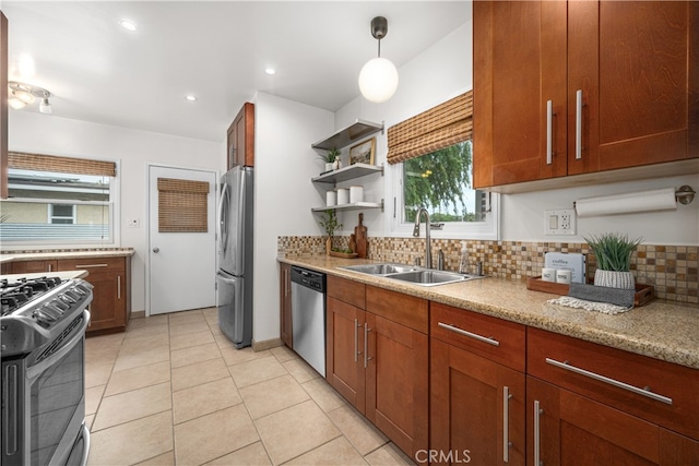 kitchen with a wealth of natural light, tasteful backsplash, stainless steel appliances, and a sink