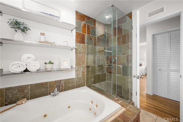 bathroom with a jetted tub, visible vents, tile patterned flooring, and a stall shower