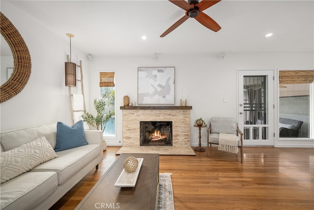 living room with recessed lighting, a premium fireplace, wood finished floors, and ceiling fan