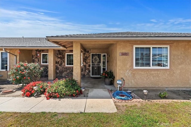 entrance to property featuring stucco siding