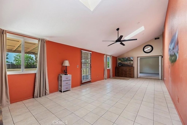 unfurnished living room with a skylight, visible vents, plenty of natural light, and light tile patterned floors