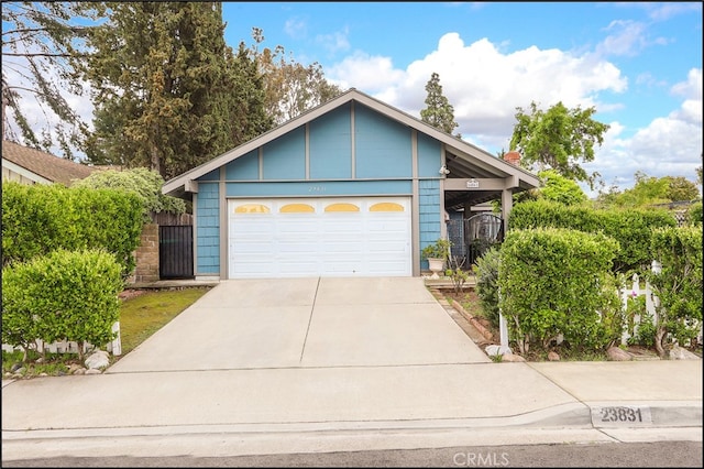 ranch-style house with concrete driveway and an attached garage