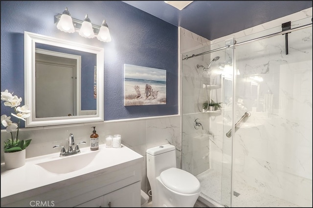bathroom featuring toilet, a textured wall, a marble finish shower, and tile walls