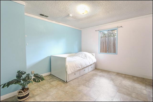 bedroom with baseboards, ornamental molding, a textured ceiling, and visible vents