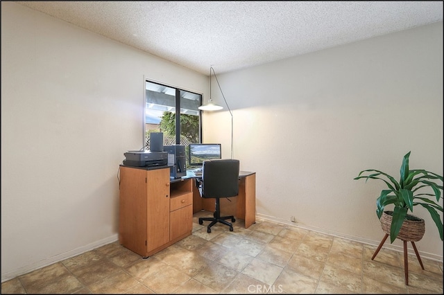 office area featuring a textured ceiling and baseboards