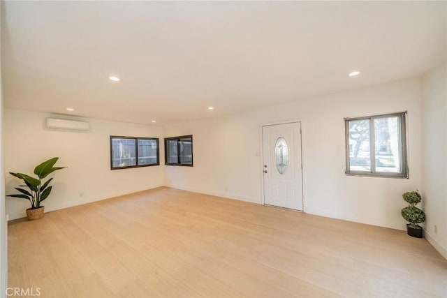 932 S Bon View Ave, Ontario, CA 91761 - entryway with an AC wall unit, light wood-style flooring, and recessed lighting