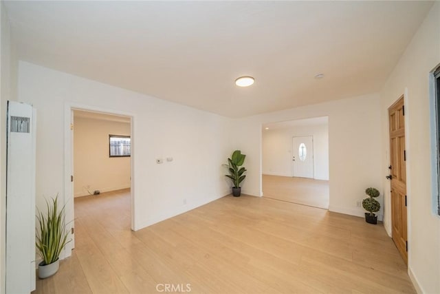932 S Bon View Ave, Ontario, CA 91761 - spare room featuring a heating unit and light wood-style flooring