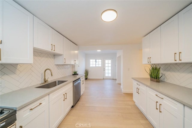 932 S Bon View Ave, Ontario, CA 91761 - kitchen featuring dishwasher, light countertops, white cabinetry, and tasteful backsplash