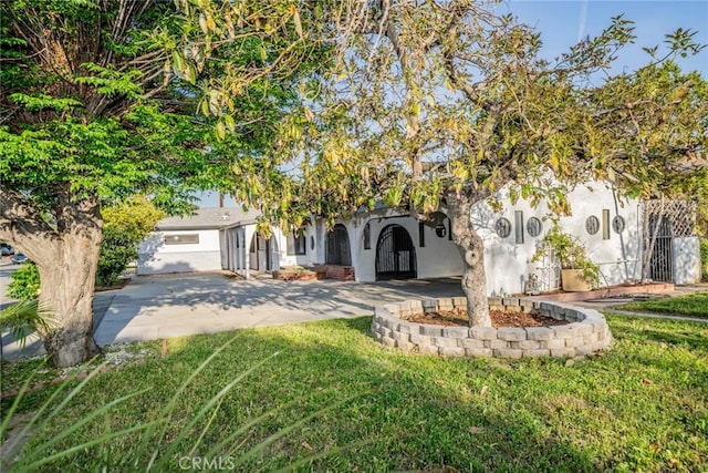 932 S Bon View Ave, Ontario, CA 91761 - view of property hidden behind natural elements featuring stucco siding and a front lawn