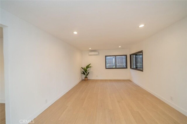 932 S Bon View Ave, Ontario, CA 91761 - spare room featuring light wood-style floors, recessed lighting, and an AC wall unit