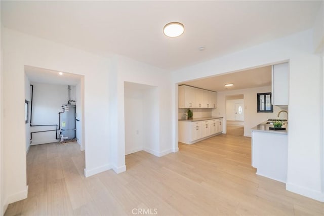 932 S Bon View Ave, Ontario, CA 91761 - unfurnished living room with water heater and light wood-type flooring