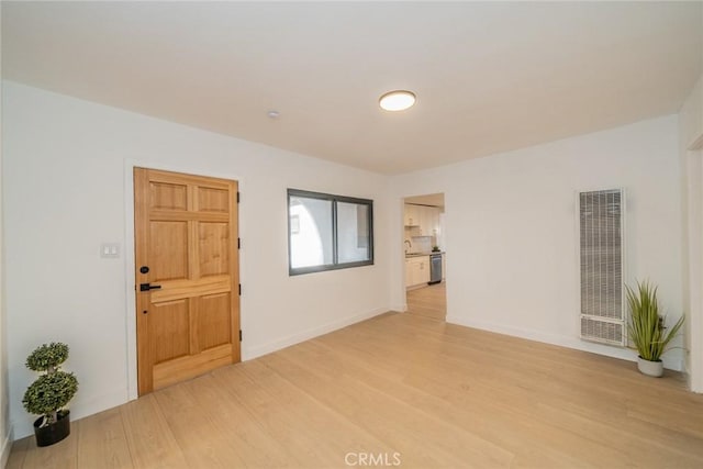 932 S Bon View Ave, Ontario, CA 91761 - empty room featuring a heating unit and light wood-type flooring