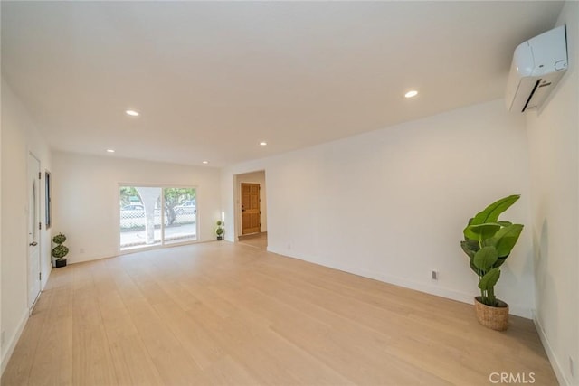 932 S Bon View Ave, Ontario, CA 91761 - unfurnished living room with a wall unit AC, light wood-style floors, and recessed lighting