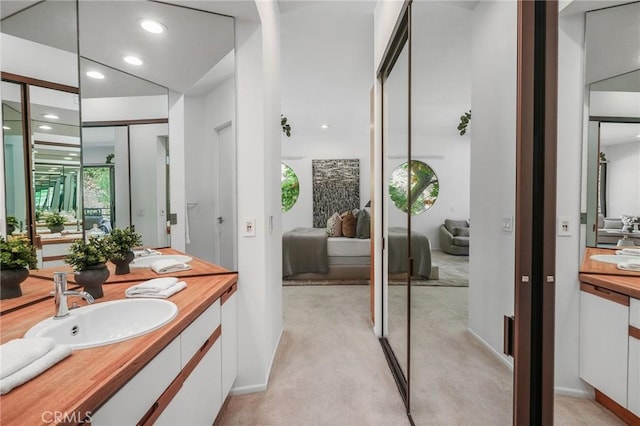 9955 Westwanda Dr, Beverly Hills, CA 90210 - full bath featuring double vanity, connected bathroom, recessed lighting, and baseboards