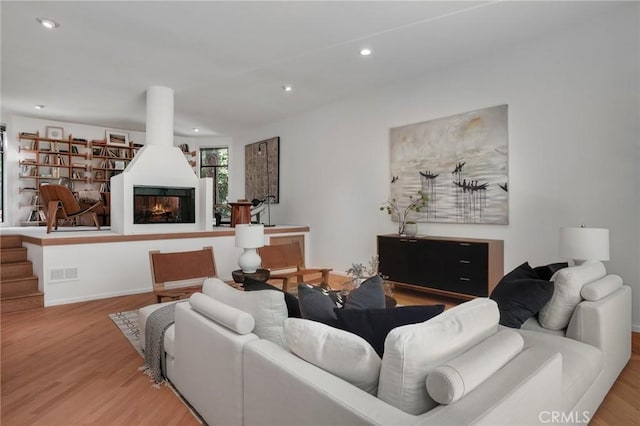 9955 Westwanda Dr, Beverly Hills, CA 90210 - living room featuring wood finished floors, recessed lighting, a lit fireplace, and baseboards
