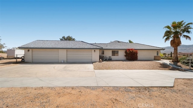 18668 Lemert St, Hesperia, CA 92345 - ranch-style house featuring concrete driveway, stucco siding, an attached garage, and a tile roof