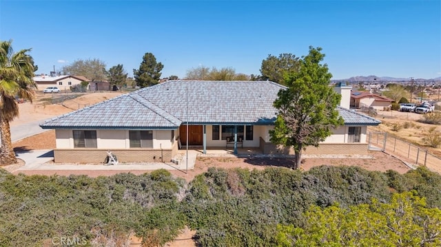18668 Lemert St, Hesperia, CA 92345 - back of property with a tile roof, fence, a patio, and stucco siding