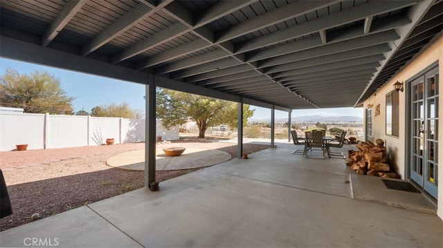 18668 Lemert St, Hesperia, CA 92345 - view of patio / terrace featuring a mountain view, outdoor dining area, a fenced backyard, and french doors
