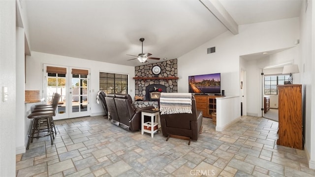 18668 Lemert St, Hesperia, CA 92345 - living area featuring visible vents, a stone fireplace, a ceiling fan, vaulted ceiling with beams, and stone finish flooring