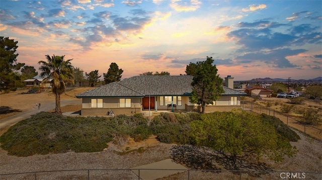 18668 Lemert St, Hesperia, CA 92345 - view of front of property with a mountain view, stucco siding, and fence