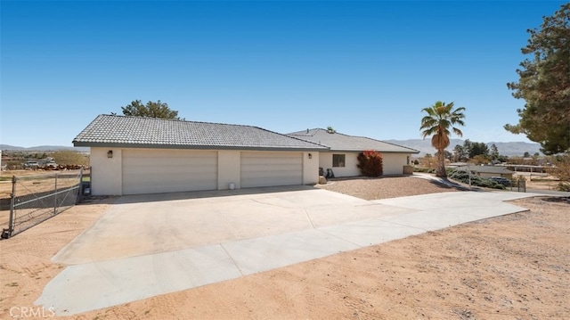 18668 Lemert St, Hesperia, CA 92345 - ranch-style house featuring a tiled roof, stucco siding, fence, an attached garage, and concrete driveway