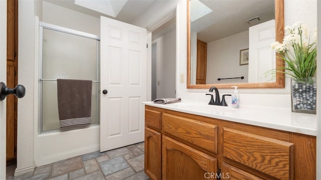18668 Lemert St, Hesperia, CA 92345 - full bathroom with stone finish floor, vanity, combined bath / shower with glass door, and visible vents