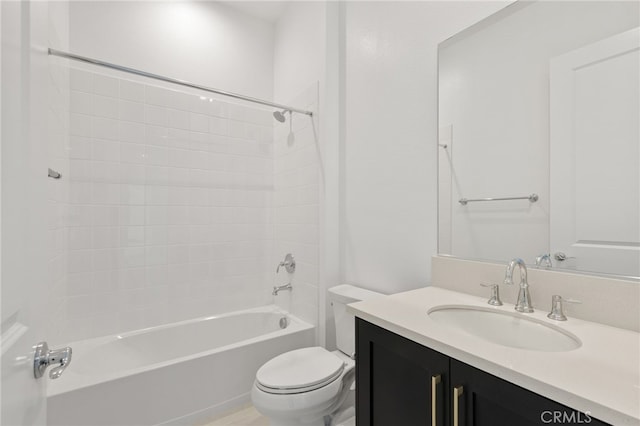 bathroom with washtub / shower combination, vanity, and toilet