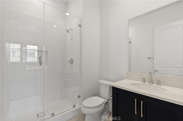 full bathroom with vanity, toilet, and a stall shower