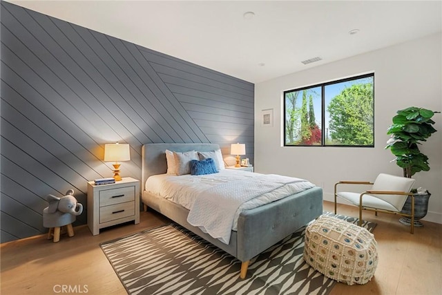 bedroom featuring wood finished floors and baseboards