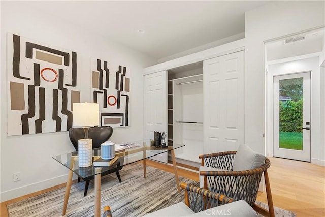 office space featuring baseboards and wood finished floors