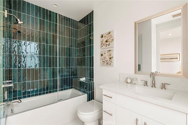 bathroom with toilet, combined bath / shower with glass door, and vanity