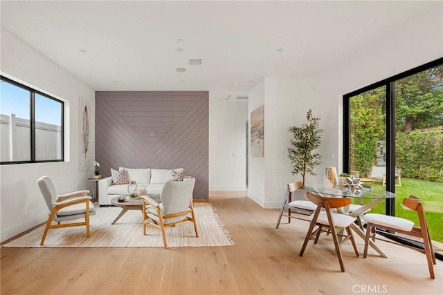 living area with baseboards and light wood-style flooring