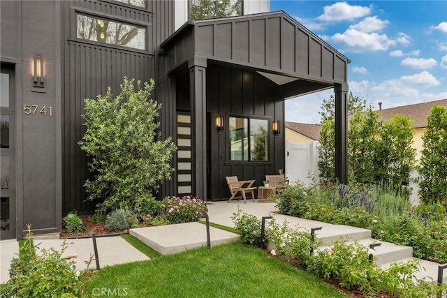 view of exterior entry with board and batten siding