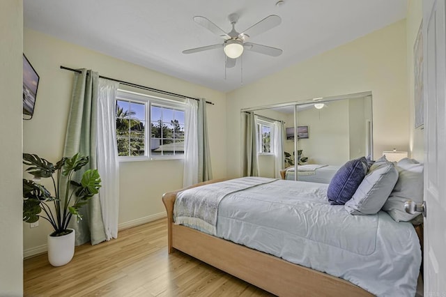bedroom featuring baseboards, wood finished floors, a closet, and ceiling fan