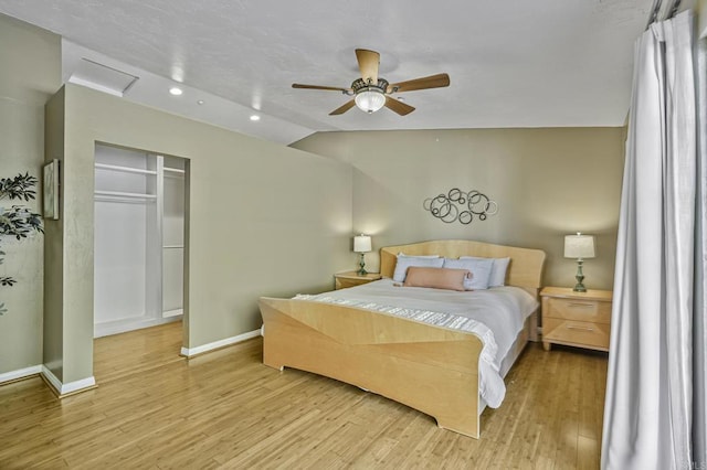 bedroom with a ceiling fan, wood finished floors, baseboards, lofted ceiling, and recessed lighting
