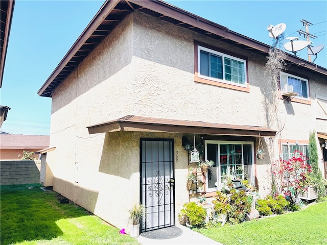 7260 Richfield St Unit 305, Paramount, CA 90723 - view of front of house with fence, stucco siding, and a front yard