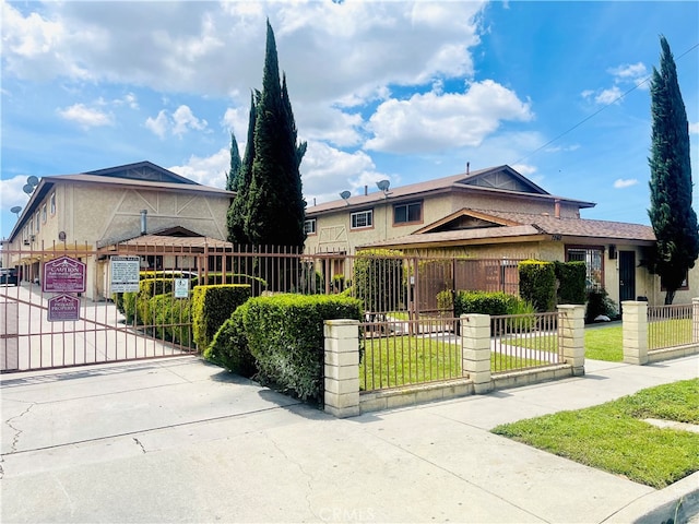 7260 Richfield St Unit 305, Paramount, CA 90723 - view of front of house with a gate, a fenced front yard, and a front yard